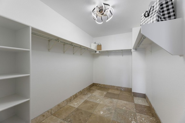 6828 Walkup Ln, Austin, TX 78747 - walk in closet with stone tile flooring