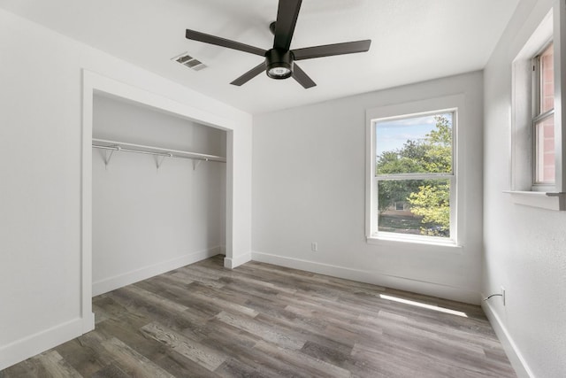 6828 Walkup Ln, Austin, TX 78747 - unfurnished bedroom with wood finished floors, a closet, and a ceiling fan