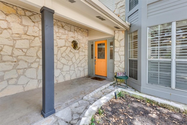 5731 Sam Houston Cir, Austin, TX 78731 - doorway to property featuring stone siding