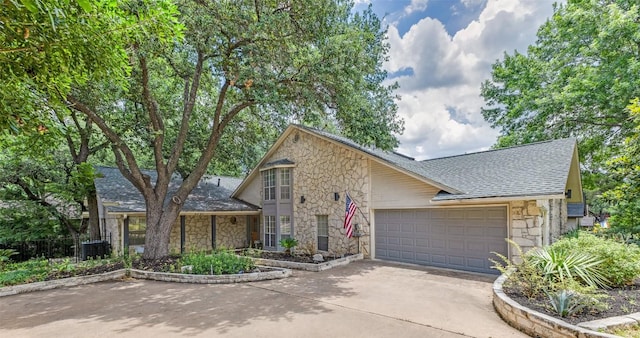 5731 Sam Houston Cir, Austin, TX 78731 - view of front of home with stone siding, roof with shingles, a garage, and driveway
