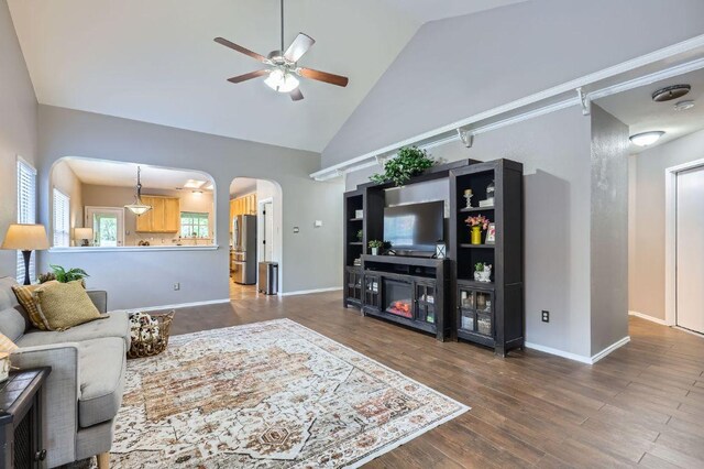 803 Hank Aaron Ln, Round Rock, TX 78665 - living room featuring a ceiling fan, arched walkways, high vaulted ceiling, and wood finished floors