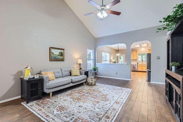 803 Hank Aaron Ln, Round Rock, TX 78665 - living room featuring a ceiling fan, high vaulted ceiling, wood finished floors, and arched walkways