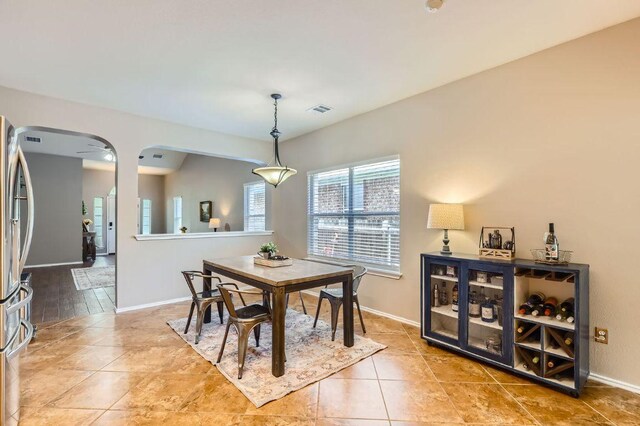 803 Hank Aaron Ln, Round Rock, TX 78665 - tiled dining room with baseboards and arched walkways
