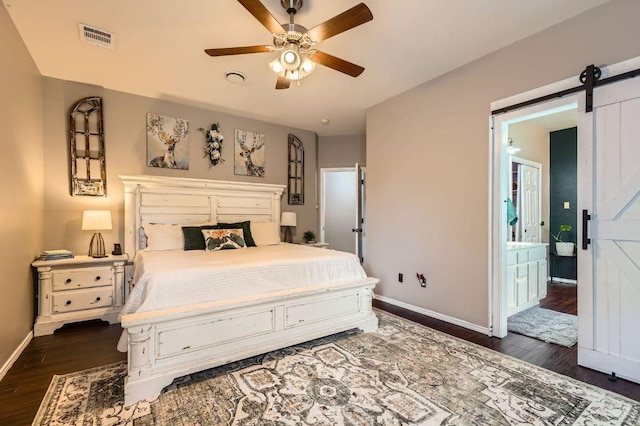 803 Hank Aaron Ln, Round Rock, TX 78665 - bedroom featuring dark wood finished floors, a barn door, and a ceiling fan