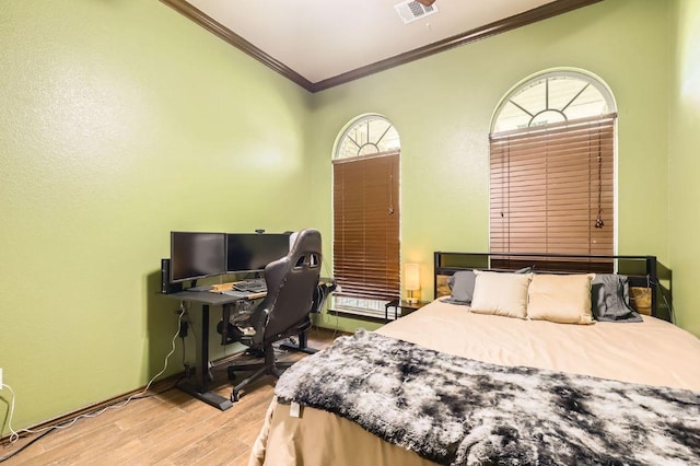 803 Hank Aaron Ln, Round Rock, TX 78665 - bedroom with ornamental molding, wood finished floors, and an office area