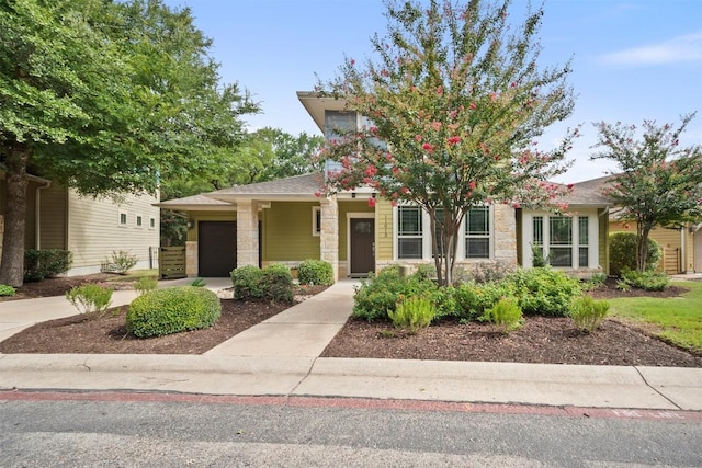 11013 Avery Station Loop Unit 31, Austin, TX 78717 - view of front of house featuring stone siding, an attached garage, and driveway