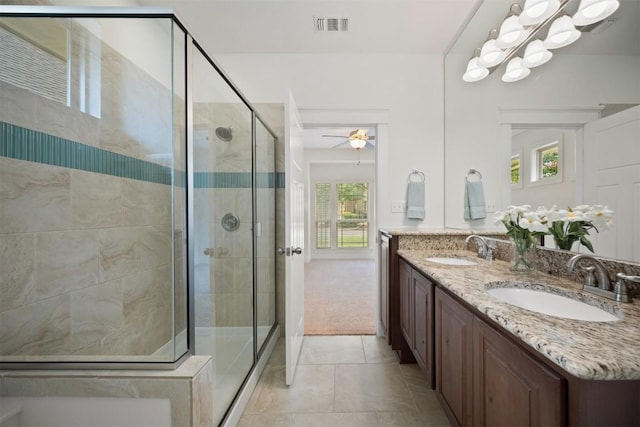 11013 Avery Station Loop Unit 31, Austin, TX 78717 - bathroom with double vanity, a stall shower, a ceiling fan, and tile patterned flooring