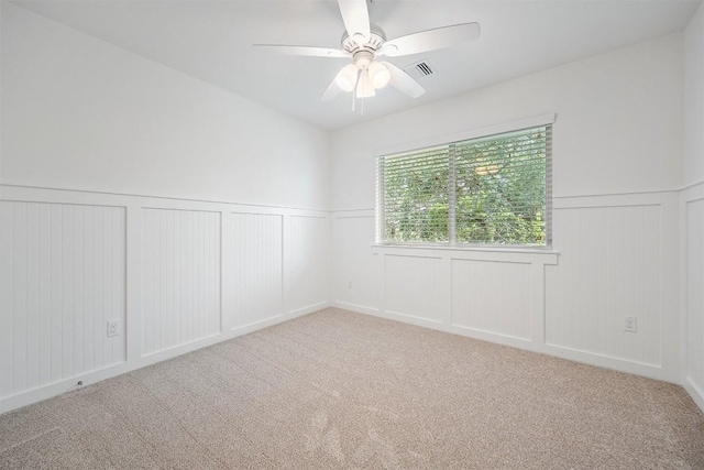 11013 Avery Station Loop Unit 31, Austin, TX 78717 - carpeted spare room with a decorative wall, ceiling fan, and a wainscoted wall
