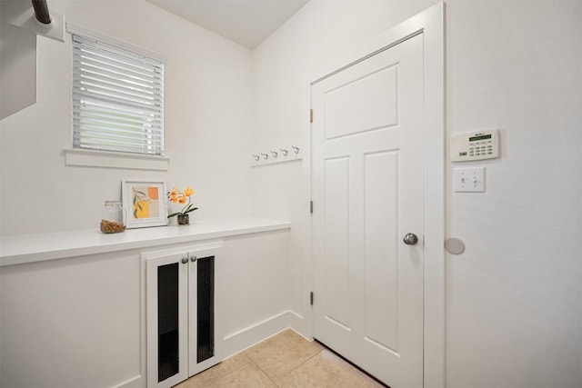 11013 Avery Station Loop Unit 31, Austin, TX 78717 - laundry room featuring light tile patterned floors and baseboards