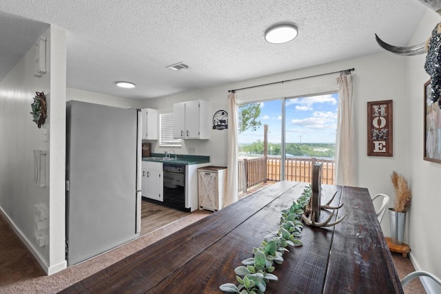 8104 Bronco Ln, Lago Vista, TX 78645 - dining space featuring a textured ceiling and light wood-type flooring