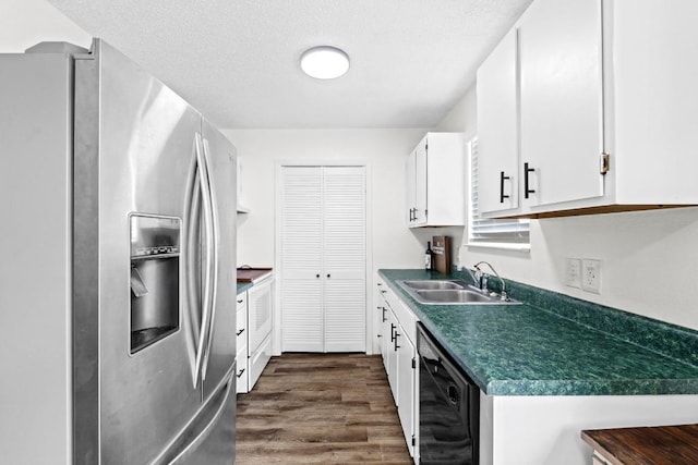8104 Bronco Ln, Lago Vista, TX 78645 - kitchen with stainless steel fridge with ice dispenser, black dishwasher, dark countertops, dark wood-style flooring, and white cabinetry