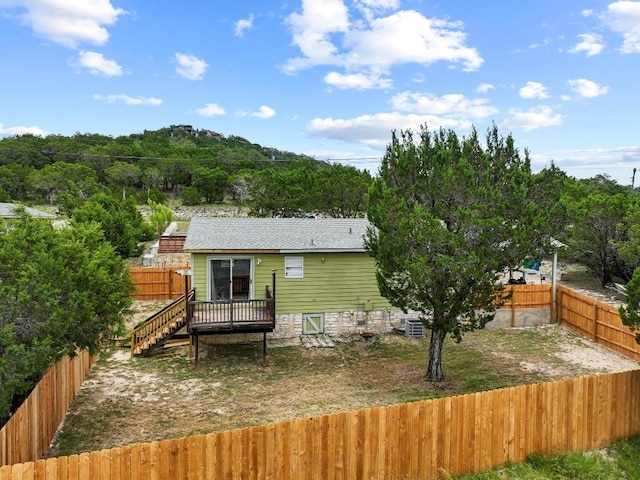 8104 Bronco Ln, Lago Vista, TX 78645 - back of house featuring a fenced backyard and a wooden deck