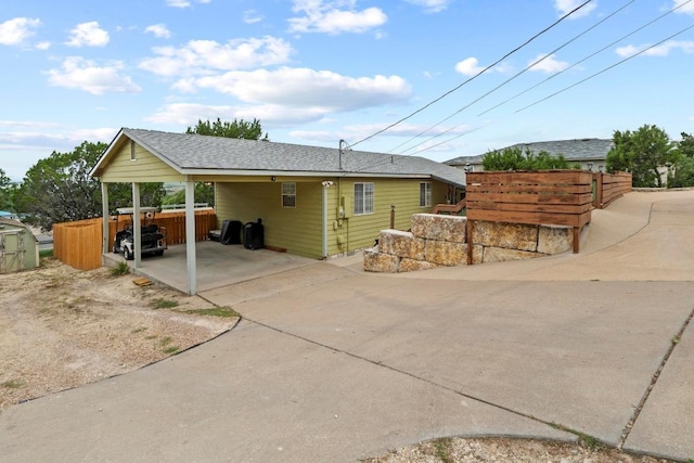 8104 Bronco Ln, Lago Vista, TX 78645 - view of front of house with concrete driveway and a carport