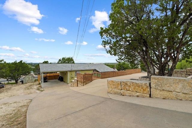 8104 Bronco Ln, Lago Vista, TX 78645 - view of front of house featuring a storage unit and driveway