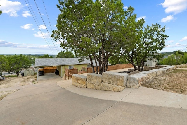 8104 Bronco Ln, Lago Vista, TX 78645 - view of front of property with a shed, a carport, and driveway