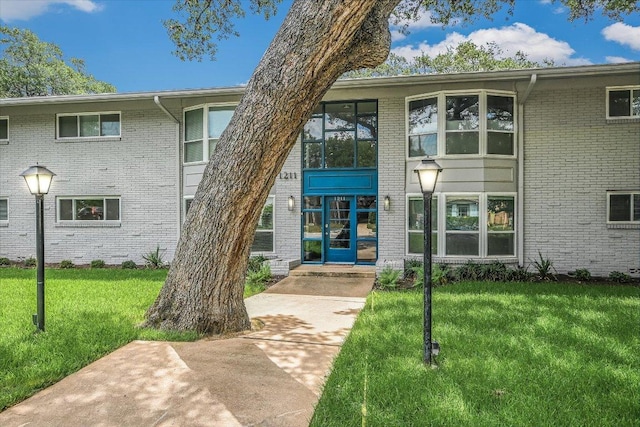 1210 Windsor Rd Unit 113, Austin, TX 78703 - view of front of property with a front lawn and brick siding