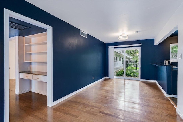 1210 Windsor Rd Unit 113, Austin, TX 78703 - unfurnished dining area with wood finished floors and healthy amount of natural light