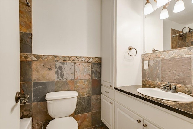 1210 Windsor Rd Unit 113, Austin, TX 78703 - full bathroom with tile walls, vanity, a tile shower, and a wainscoted wall