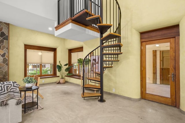 913 Taulbee Ln, Austin, TX 78757 - staircase featuring concrete flooring and a towering ceiling
