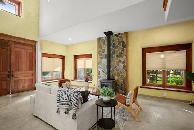 913 Taulbee Ln, Austin, TX 78757 - living room with finished concrete flooring, a wood stove, and healthy amount of natural light