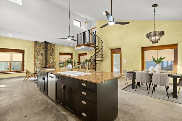 913 Taulbee Ln, Austin, TX 78757 - kitchen with a ceiling fan, high vaulted ceiling, dishwasher, a wood stove, and an island with sink