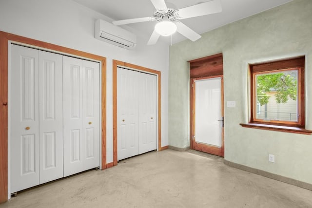 913 Taulbee Ln, Austin, TX 78757 - unfurnished bedroom with a wall mounted AC, multiple closets, concrete floors, and a ceiling fan