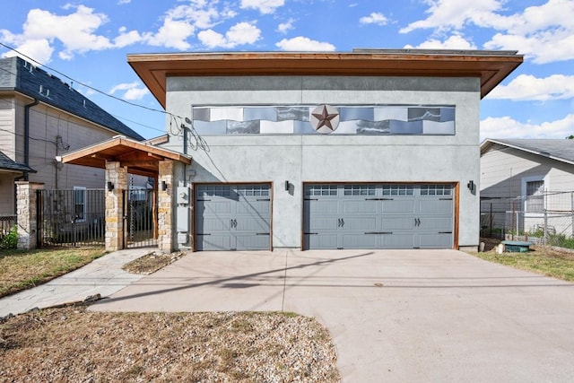 913 Taulbee Ln, Austin, TX 78757 - view of front of property with stucco siding, concrete driveway, a gate, and an attached garage
