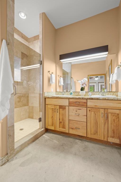 913 Taulbee Ln, Austin, TX 78757 - bathroom featuring a stall shower and double vanity