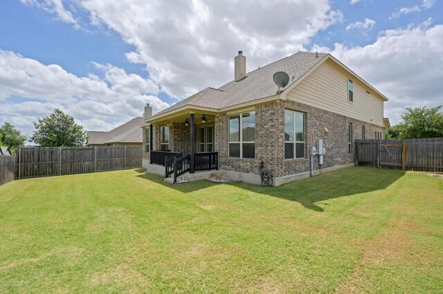 1113 Hartman Dr, Leander, TX 78641 - rear view of property with ceiling fan, brick siding, and a fenced backyard