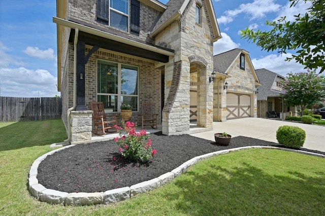 1113 Hartman Dr, Leander, TX 78641 - view of front of home featuring stone siding, brick siding, concrete driveway, and an attached garage