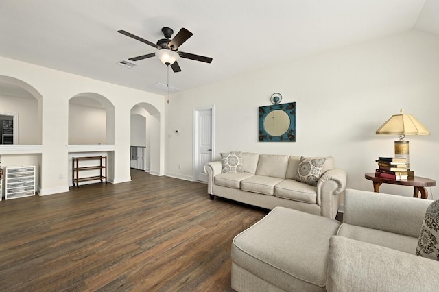 1113 Hartman Dr, Leander, TX 78641 - living room featuring a ceiling fan, dark wood finished floors, and arched walkways