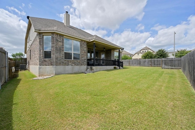 1113 Hartman Dr, Leander, TX 78641 - back of property with brick siding, a fenced backyard, ceiling fan, and a chimney
