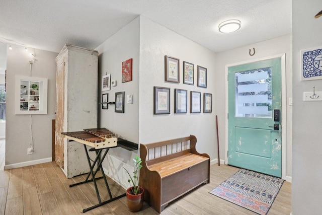 6803 Moonmont Dr, Austin, TX 78745 - foyer entrance featuring light wood finished floors and a textured ceiling