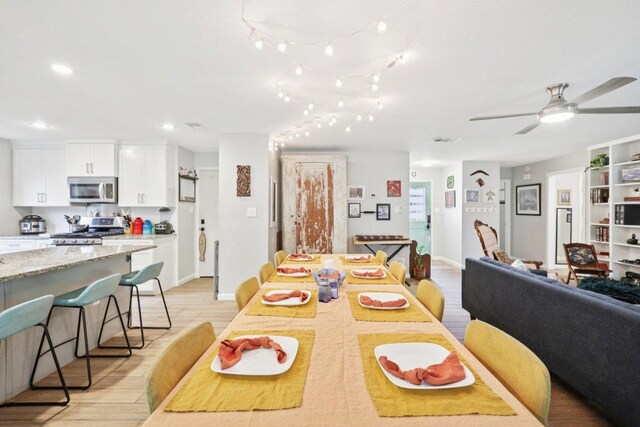 6803 Moonmont Dr, Austin, TX 78745 - dining area with light wood finished floors, a ceiling fan, and recessed lighting