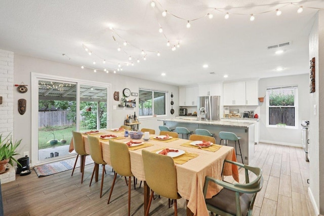 6803 Moonmont Dr, Austin, TX 78745 - dining space with light wood finished floors and recessed lighting