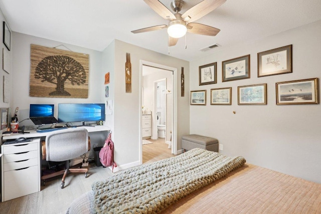 6803 Moonmont Dr, Austin, TX 78745 - bedroom with light wood finished floors, a desk, a ceiling fan, and connected bathroom
