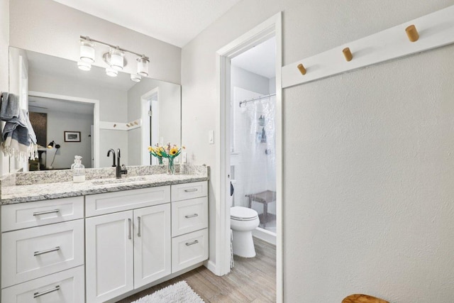 6803 Moonmont Dr, Austin, TX 78745 - bathroom with wood finished floors, vanity, and a shower with curtain