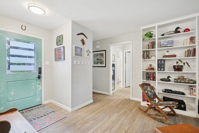 6803 Moonmont Dr, Austin, TX 78745 - entryway with light wood-type flooring and a textured ceiling
