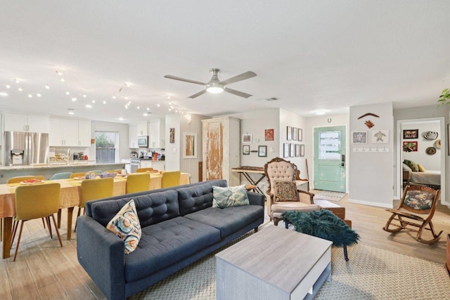 6803 Moonmont Dr, Austin, TX 78745 - living area with light wood-style flooring and a ceiling fan