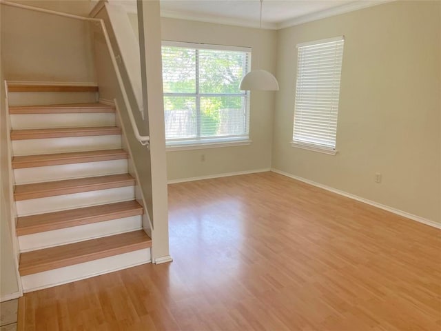 8501 Bismark Cv, Austin, TX 78745 - stairway with wood finished floors and ornamental molding