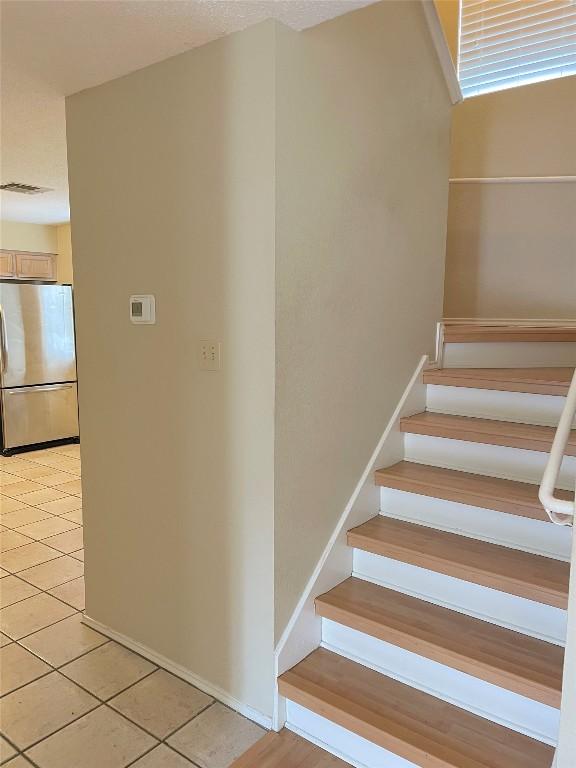 8501 Bismark Cv, Austin, TX 78745 - staircase featuring tile patterned flooring and baseboards