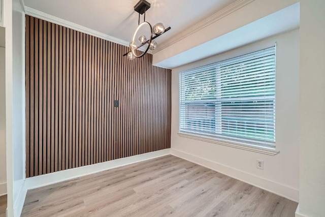 6102 Amber Pass, Austin, TX 78745 - unfurnished dining area with a chandelier, crown molding, and light wood-style flooring
