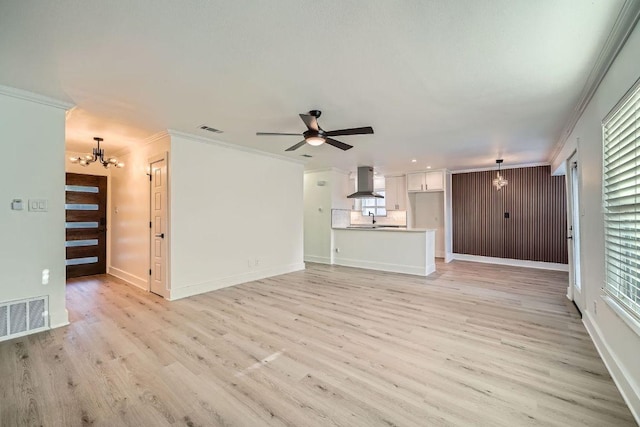 6102 Amber Pass, Austin, TX 78745 - unfurnished living room with a chandelier, light wood finished floors, crown molding, and a ceiling fan