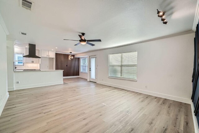 6102 Amber Pass, Austin, TX 78745 - unfurnished living room featuring light wood finished floors, a ceiling fan, crown molding, and recessed lighting