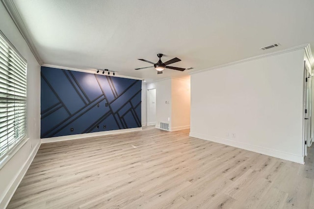 6102 Amber Pass, Austin, TX 78745 - spare room featuring ornamental molding, light wood-style flooring, ceiling fan, and a decorative wall