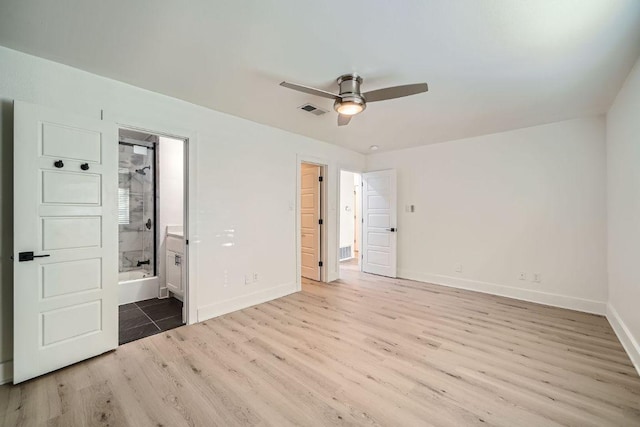 6102 Amber Pass, Austin, TX 78745 - unfurnished bedroom featuring light wood-style floors and ensuite bathroom