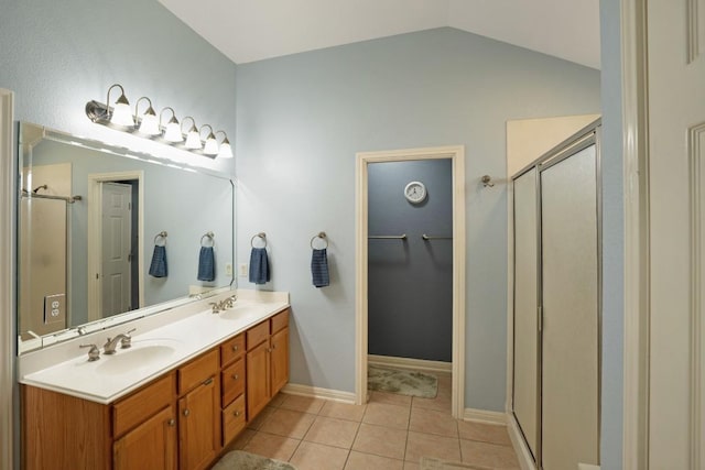 213 S Buffalo Pass, Georgetown, TX 78633 - bathroom featuring a shower stall, double vanity, tile patterned flooring, vaulted ceiling, and a spacious closet