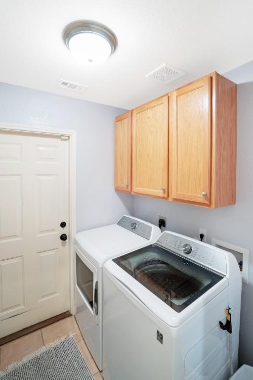 213 S Buffalo Pass, Georgetown, TX 78633 - laundry room featuring cabinet space, independent washer and dryer, and light tile patterned floors