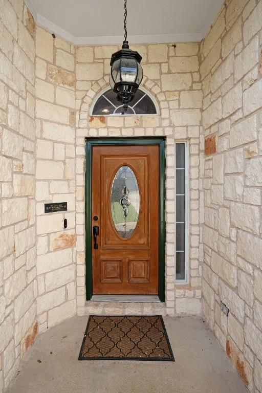 213 S Buffalo Pass, Georgetown, TX 78633 - doorway to property with stone siding
