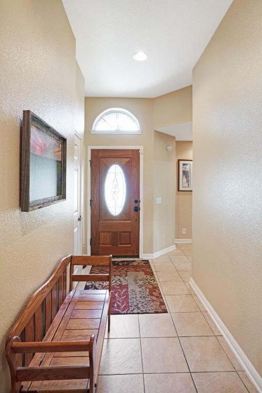 213 S Buffalo Pass, Georgetown, TX 78633 - foyer with light tile patterned floors and baseboards